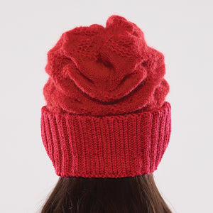 Women's winter Orion Earmuff Hat shown in the colour cardinal.